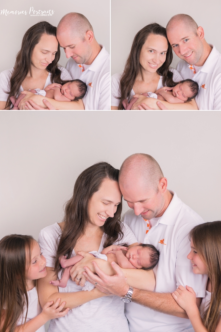 traditional baby squish session with newborn, mom, dad and two sisters wearing white with white background.