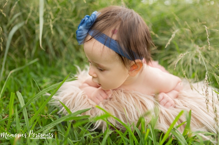 3 month old baby girl discovering grass for the first time