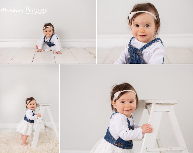 9 month old baby girl in portrait studio standing on a ladder