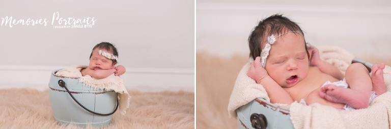newborn in squish poses in pale blue bucket and furry blanket