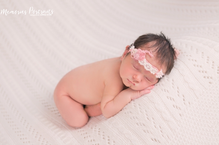 sleeping newborn on white knit blanket