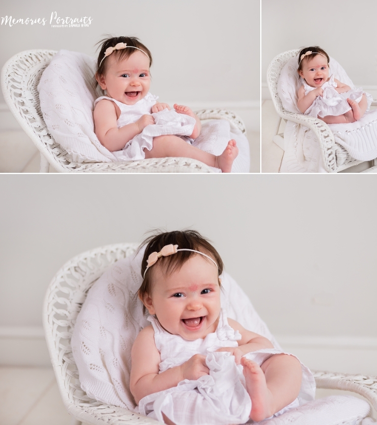 3 month old baby girl sitting in white wicker chair