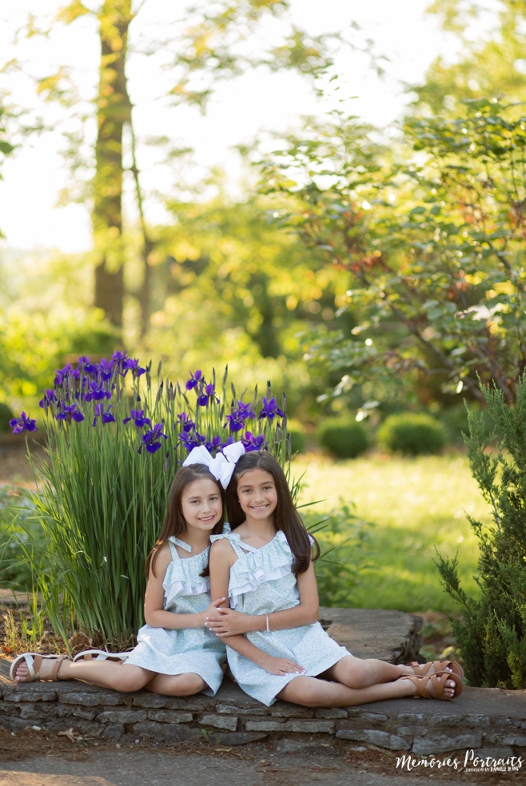 brunette sisters perfectly matching in flower garden